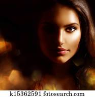 Beauty Girl Dark Portrait with Golden Sparks. Mysterious Woman 