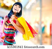 Beauty Woman with Shopping Bags in Shopping Mall Beauty Woman with Shopping Bags in Shopping Mall
