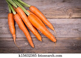 Bunch of fresh carrots over vintage wood background. Bunch of fresh carrots over vintage wood background.