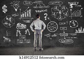 businessman in suit and business plan on grunge wall