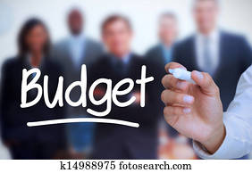 Businessman writing budget with a m Businessman writing budget with a m