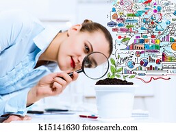 Businesswoman examining sprout