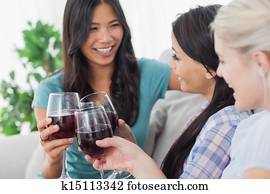 Chatting friends having red wine together