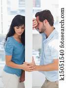 Couple are separated by white wall