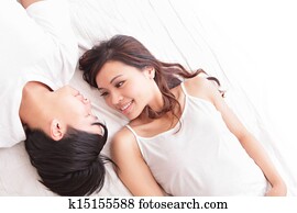 couple happy smile looking to each other in bed