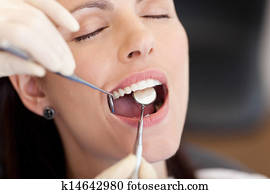 Dentist Examining Female Patient At Clinic Dentist Examining Female Patient At Clinic