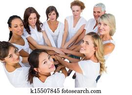 Female models joining hands in a circle and looking at camera