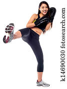 Fit slim girl practising kick boxing