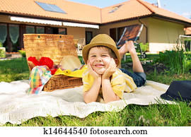 Glad little boy in the garden