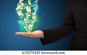Glowing money in the hand of a businessman
