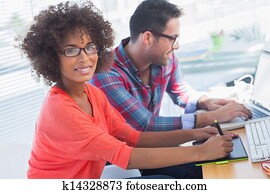 Graphic designer using a graphics tablet in her office Graphic designer using a graphics tablet in her office