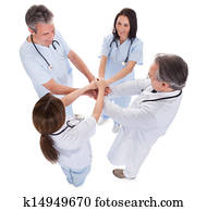 Group Of Doctors Stacking Hands Together
