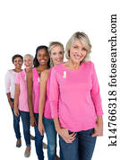 Group of women wearing pink tops and ribbons for breast cancer