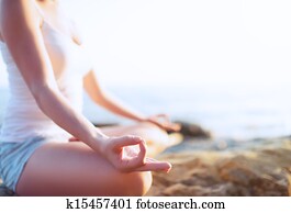 hand of  woman meditating in a yoga pose on beach