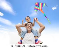 happy little girl on his father shoulder with colorful kite happy little girl on his father shoulder with colorful kite