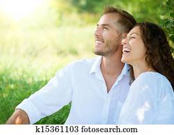 Happy Smiling Couple Relaxing in a Park