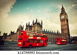 London, the UK. Red bus in motion and Big Ben