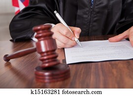 Male Judge Writing On Paper Male Judge Writing On Paper