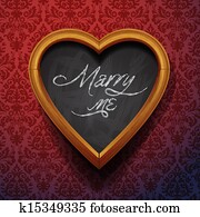 Marry Me written by chalk on heart shaped board