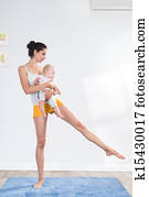 mother does gymnastics with her baby