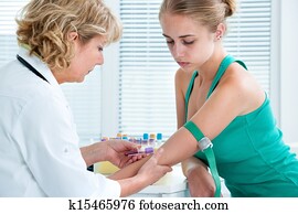Nurse taking blood sample