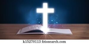 Open holy bible with glowing cross in the middle Open holy bible with glowing cross in the middle