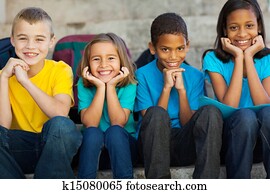 primary school children sitting outdoors