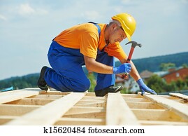 Roofer carpenter works on roof Roofer carpenter works on roof