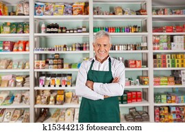 Senior Male Owner Standing In Supermarket