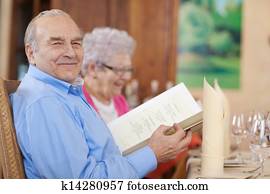 smiling senior couple in restaurant