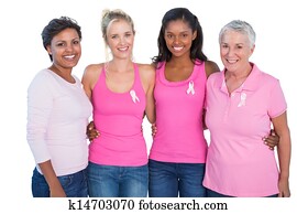 Smiling women wearing pink tops and breast cancer ribbons