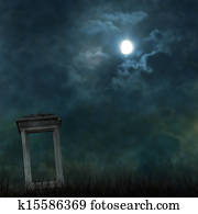 Spooky Halloween graveyard with dark clouds and ominous moon