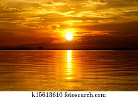 Sunset at the twilight. Beautiful clouds golden sky.