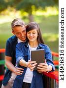 teenage couple taking self portrait outdoors
