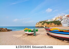 The beach at the village of Carvoeiro with fishing boats in the foreground. Portugal, summer.