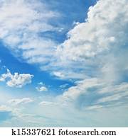 The white cumulus clouds against the blue sky