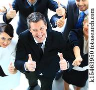 Top view of a happy team of business colleagues gesturing a thumbs up sign