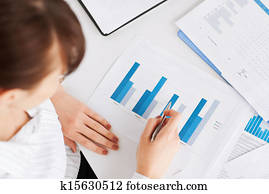woman hand with charts and papers woman hand with charts and papers