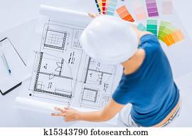 woman with color samples and blueprint woman with color samples and blueprint