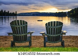 Wooden chairs at sunset on beach