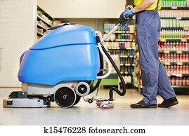 worker cleaning floor with machine worker cleaning floor with machine