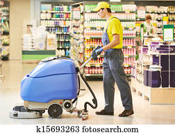 worker cleaning store floor with machine worker cleaning store floor with machine