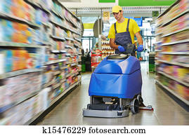 worker cleaning store floor with machine worker cleaning store floor with machine