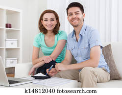 Young couple calculating budget