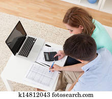 Young couple calculating budget