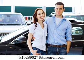 Young happy couple at car salon Young happy couple at car salon