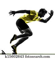 young man sprinter runner in starting blocks silhouette