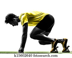 young man sprinter runner in starting blocks silhouette