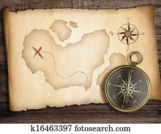 Adventure concept. Old compass on table with treasure map.