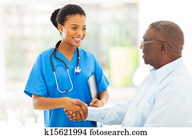 african american medical nurse handshaking with senior patient